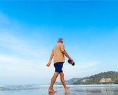 Man Walking on Beach